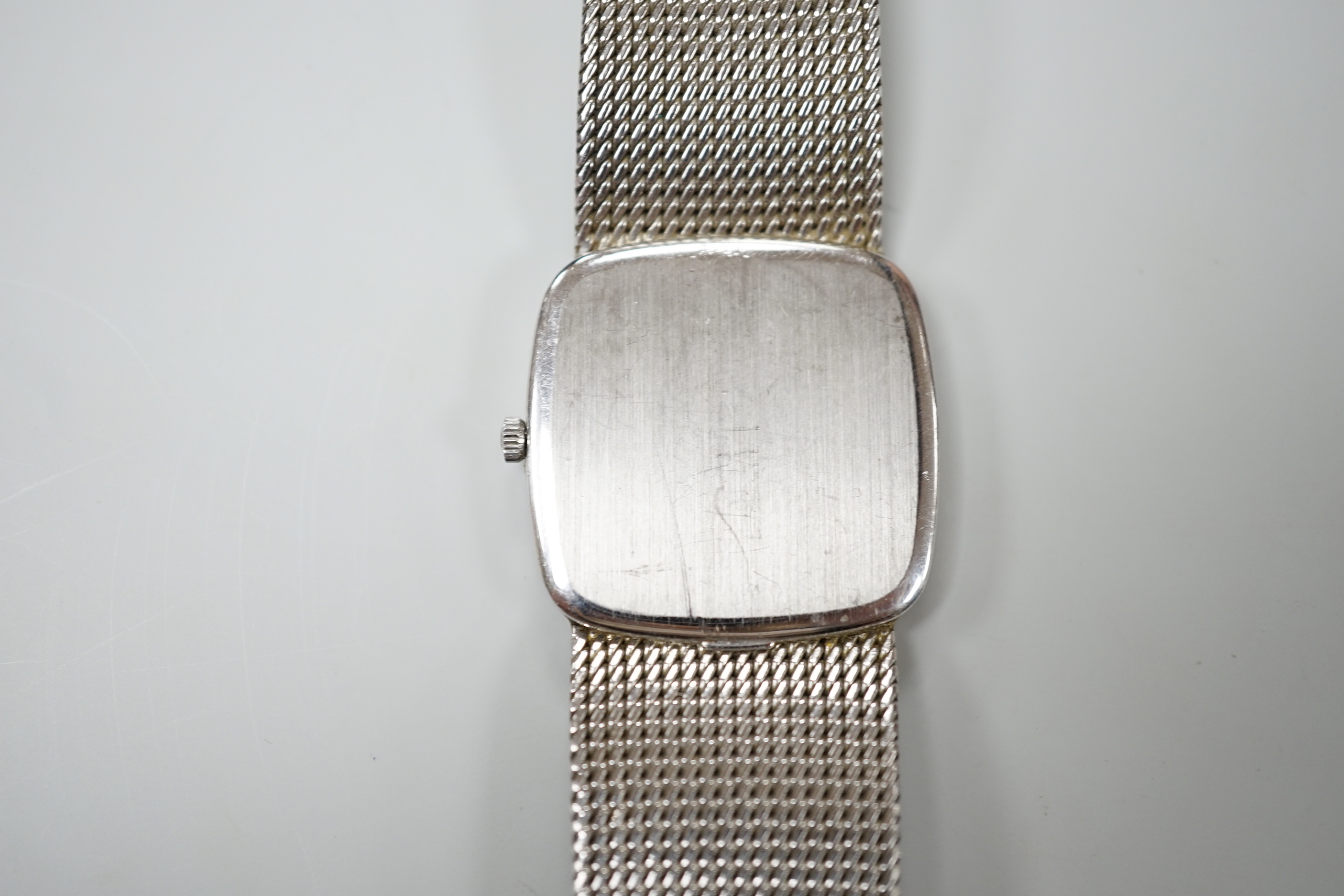 A gentleman's 1970's 750 white metal Omega Constellation manual wind dress wrist watch, on integral 750 Omega bracelet, movement c.700, with part paperwork, overall 18.3cm, gross weight 75.1 grams.